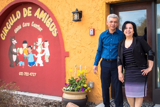 man and woman standing in front of building with sign reading "Circulo Des Amigos"